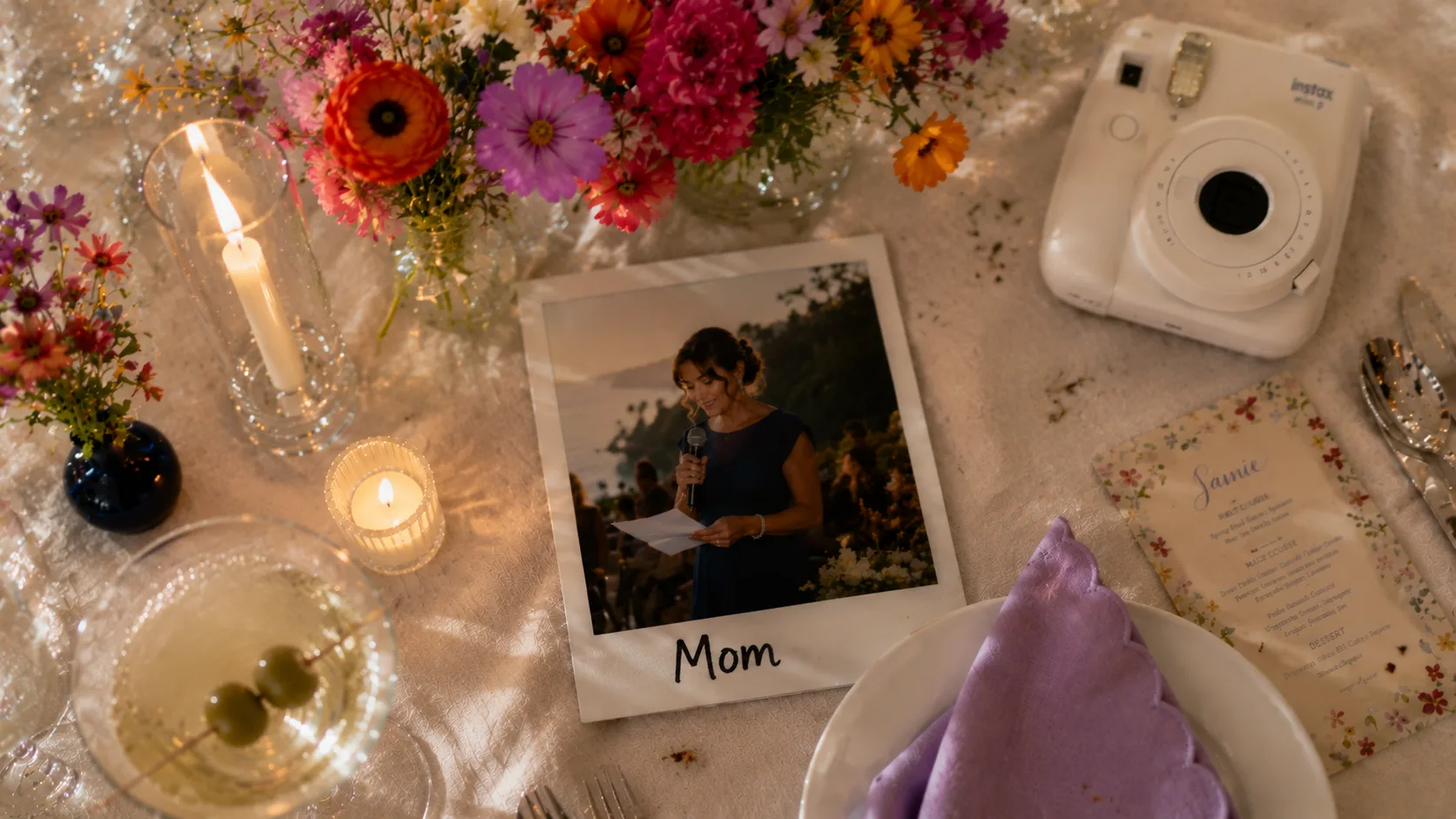 A mother giving a wedding speech, pictured in an instant photo on a reception table